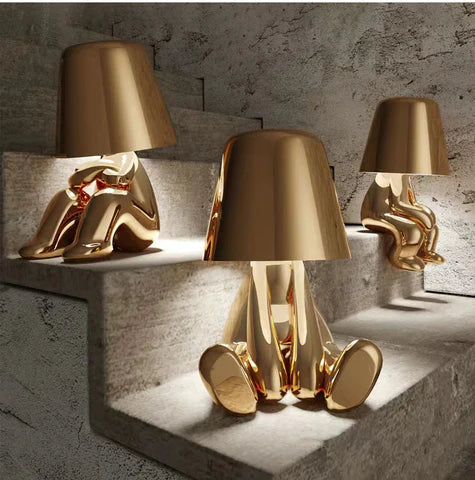 Radiate Elegance: Illuminate Your Space with the Little Golden Man Table Lamp